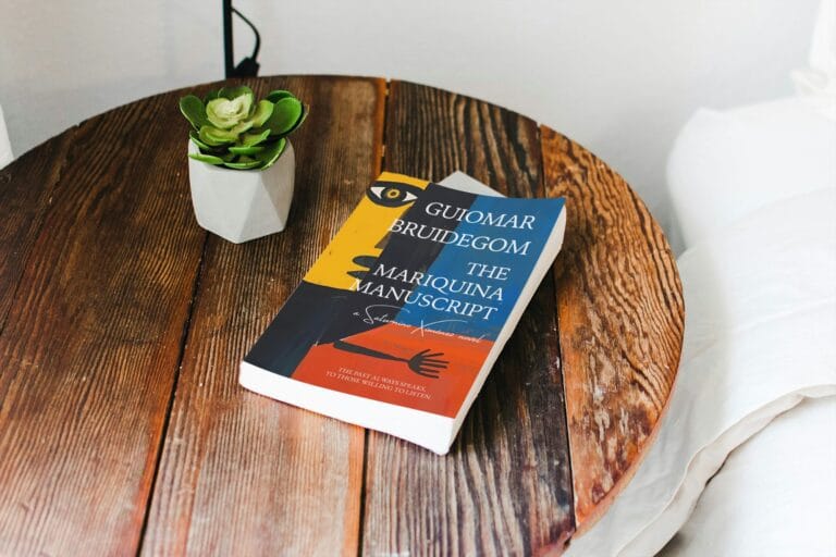 The Mariquina Manuscript - Guiomar Bruidegom - paperback on wooden table